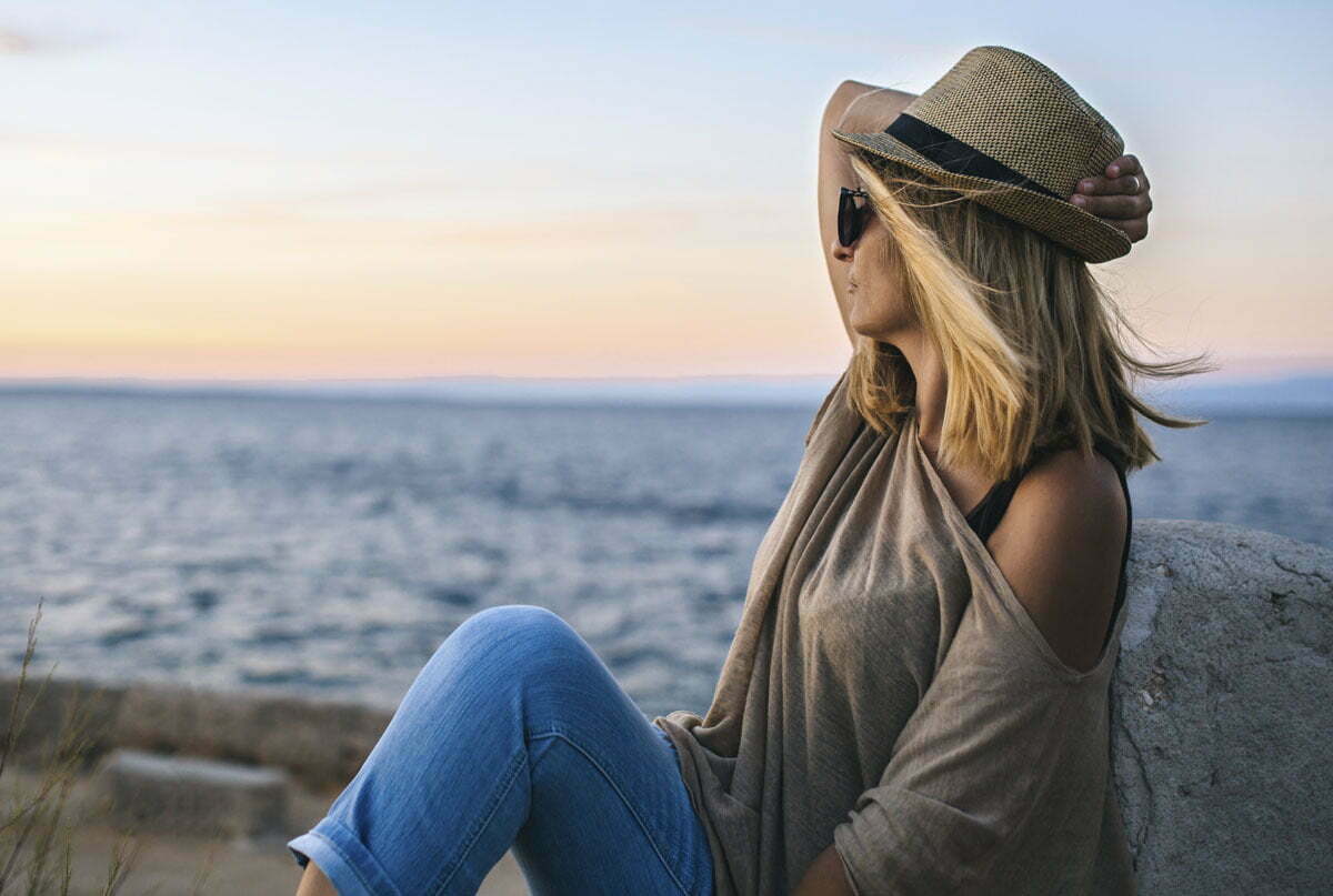 woman wearing a hat on the beach