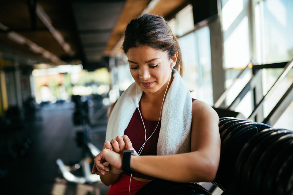 woman in the gym checking her watch