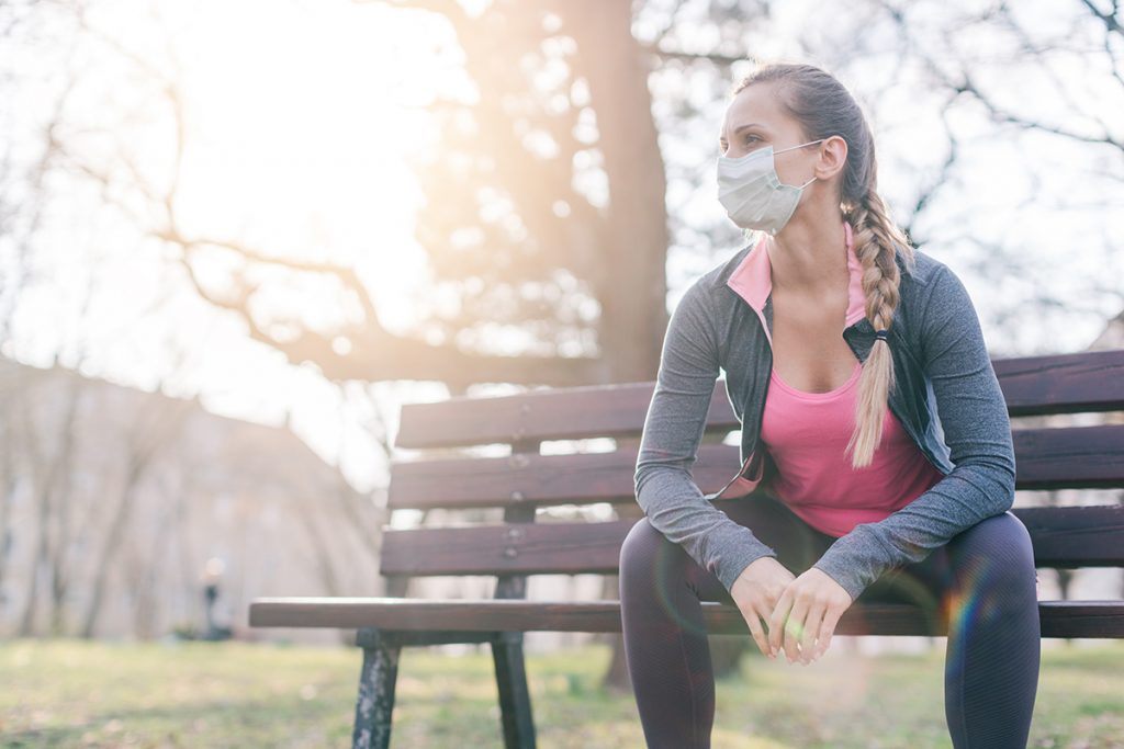 Young woman working out with mask on