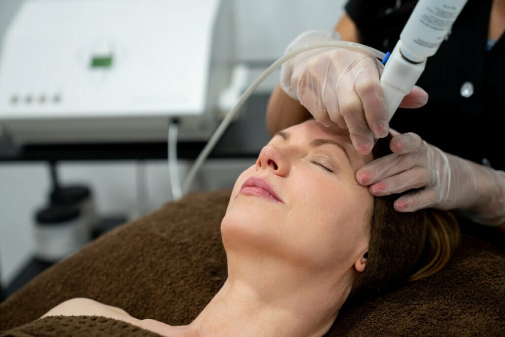 Woman at the spa getting a facial laser treatment