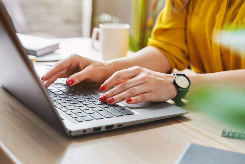 Woman Types on Laptop Computer